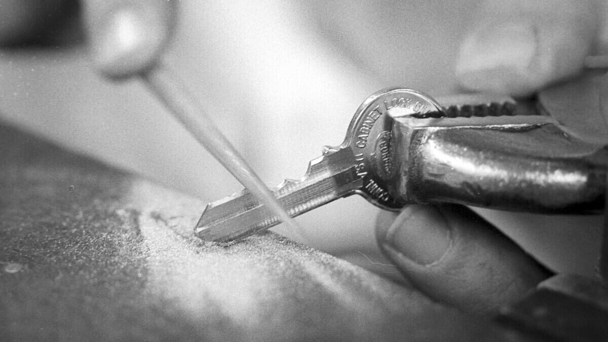 Mike Walsh hand files new key for lock with missing serial number at Cal Poly on Nov. 17, 1978.