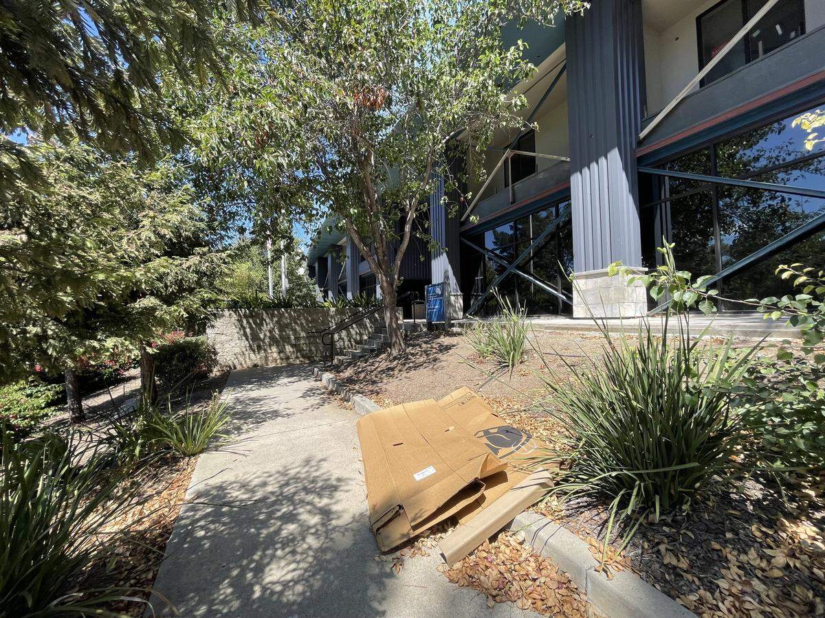 The city says a condemned property at 1150 Laurel Lane in San Luis Obispo has not been repaired and numerous safety concerns were present. Trash and construction debris, like the cardboard above, litter the property on Sept. 11, 2025. The building was home to Bang the Drum Brewery and SLO City Church.