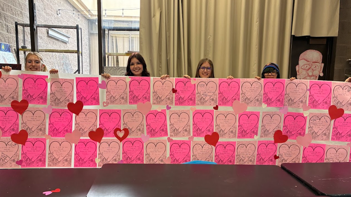 Finley Pearse, center-left, holds a Valentine’s Day card created by the Young Democrats club at San Luis Obispo High School for students at Roosevelt High School in Minneapolis. The project was organized in solidarity with students affected by ICE.