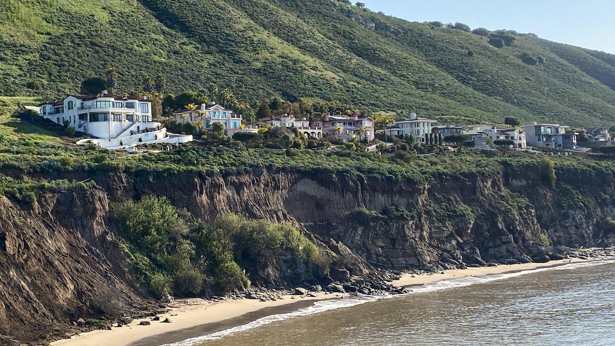 Cliffs below houses at Pirate’s Cove show significant slumping after a winter of heavy rains and storm surge, as seen here with rocks reaching the tide line on May 16, 2023.