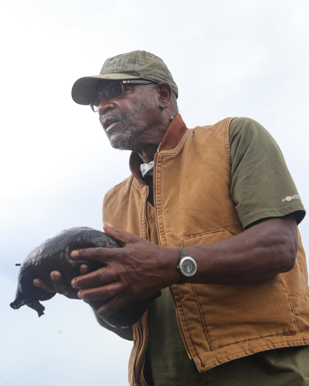 John Sanders teaches nature skills here he holds a sea hare, a type of sea slug found in Morro Bay.
