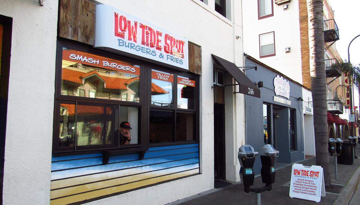 General manager and chef Ben Schutz leans out of a window at the new Low Tide Spot at 246 Pomeroy Ave. in Pismo Beach.