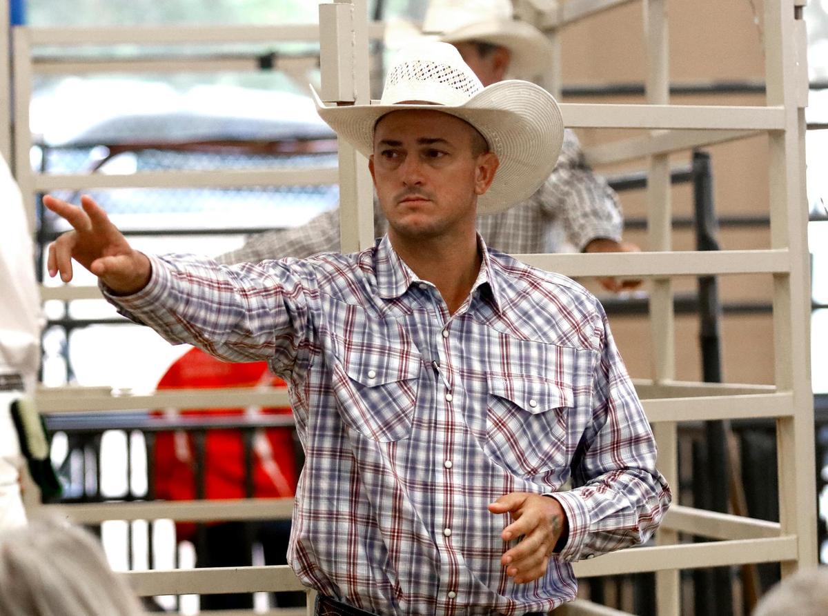 Blaine Kutcher is a “ring man” spotting the buyer’s bids with an intense look at Junior Livestock Auction at the California Mid-State Fair in Paso Robles, Saturday, July 30, 2022.