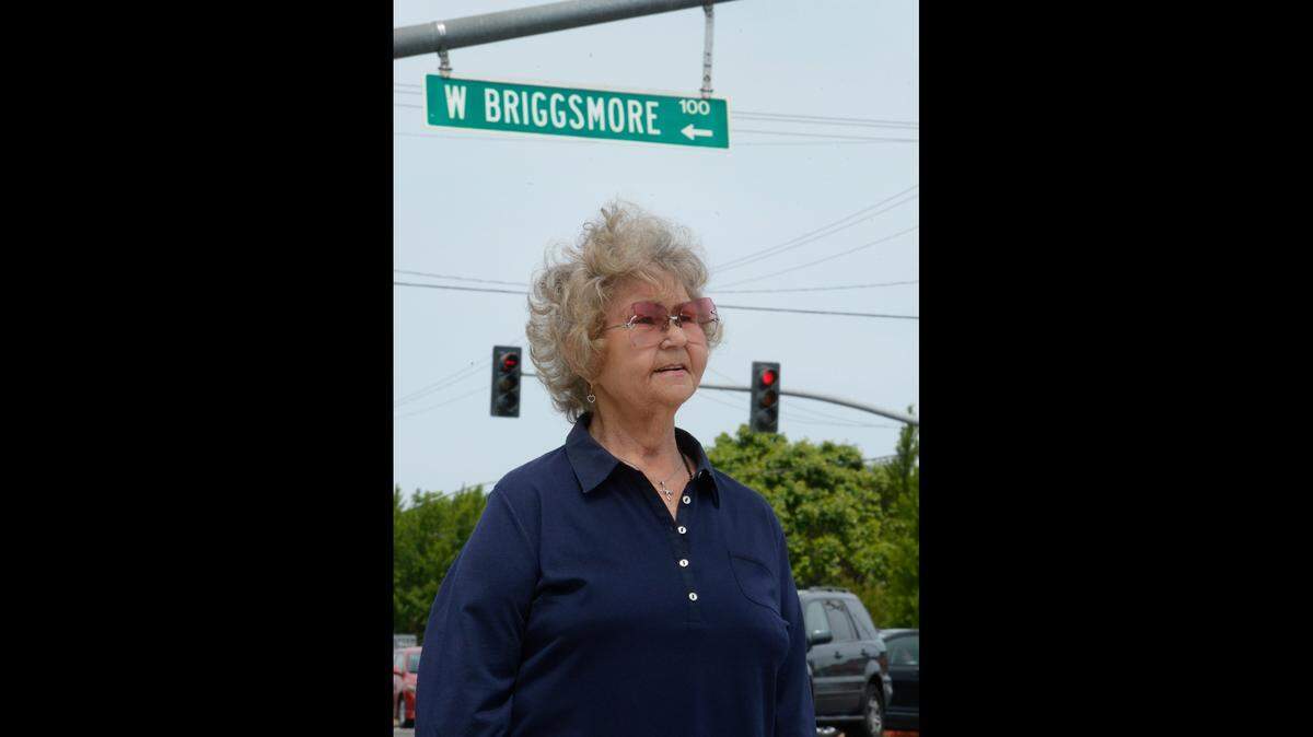 Elaine Ixcot, 76, of Modesto stands by the busy intersection of Briggsmore and McHenry avenues in Modesto in 2014. Her aunt and uncle, Rose and Russell Briggs, lived on the northwest corner of those streets.