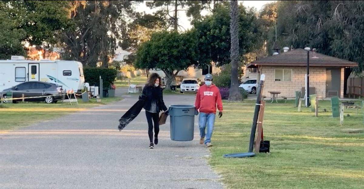 Tara Hobbs with the San Luis Obispo County Library, left, and Manuel Mendoza with the county Department of Agriculture have been reassigned to work in the same parking shelters during the COVID-19 pandemic.