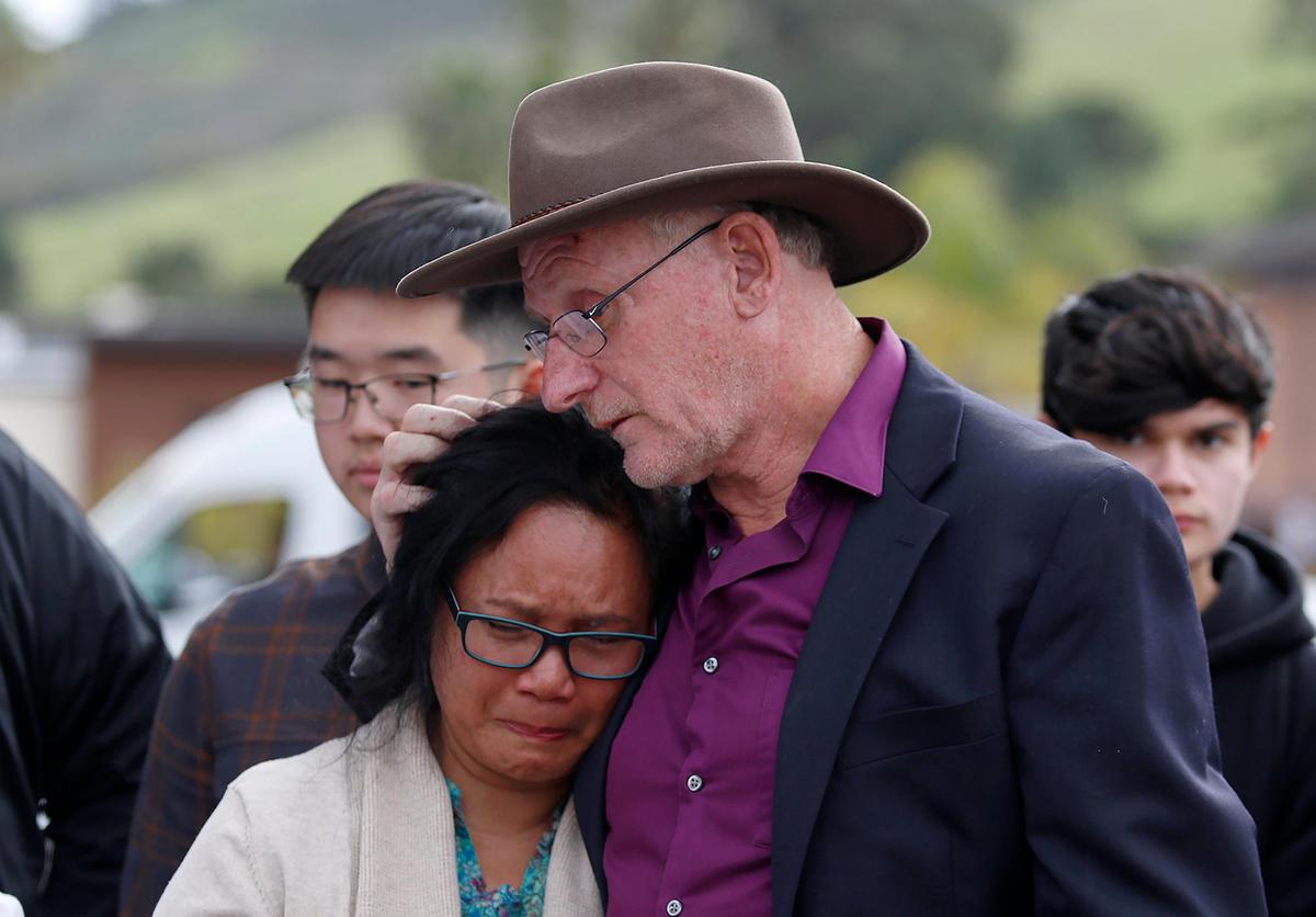 Andreas Kooi was a Cal Poly grad student who was hit by a drunk driver while he was biking on Foothill Blvd in 2021. His family is installied a “ghost bike” memorial near the scene of the accident, Saturday, Feb. 4, 2023. Jacob and Helen Kooi hug one another.