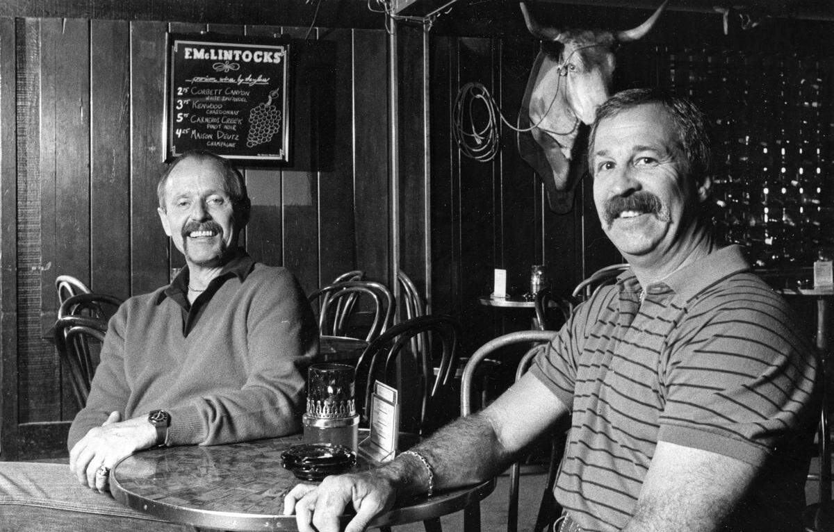F. McLintocks co-owners and founders Bruce Breault, left, and Tunny Ortali are surrounded by Western artifacts in the Pismo Beach restaurant’s saloon in an April 1988 photo.