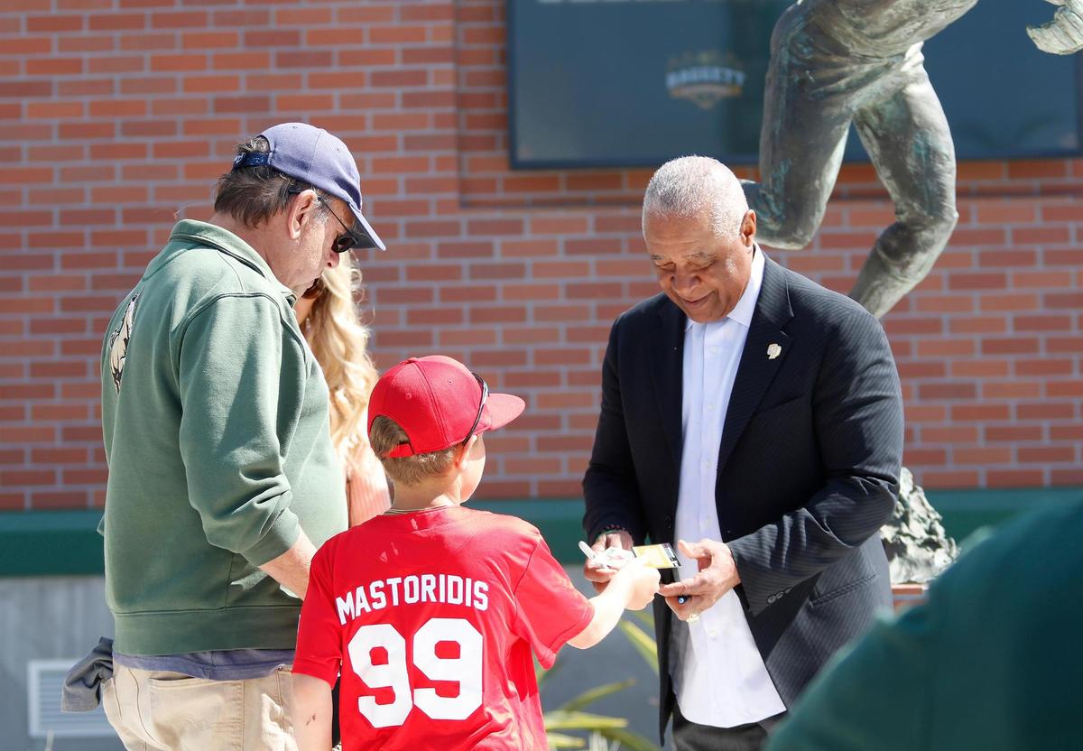 Cal Poly baseball legend Ozzie Smith greets some fans at the re-dedication of his statue and plaza at Baggett Stadium in San Luis Obispo on March 25, 2023.