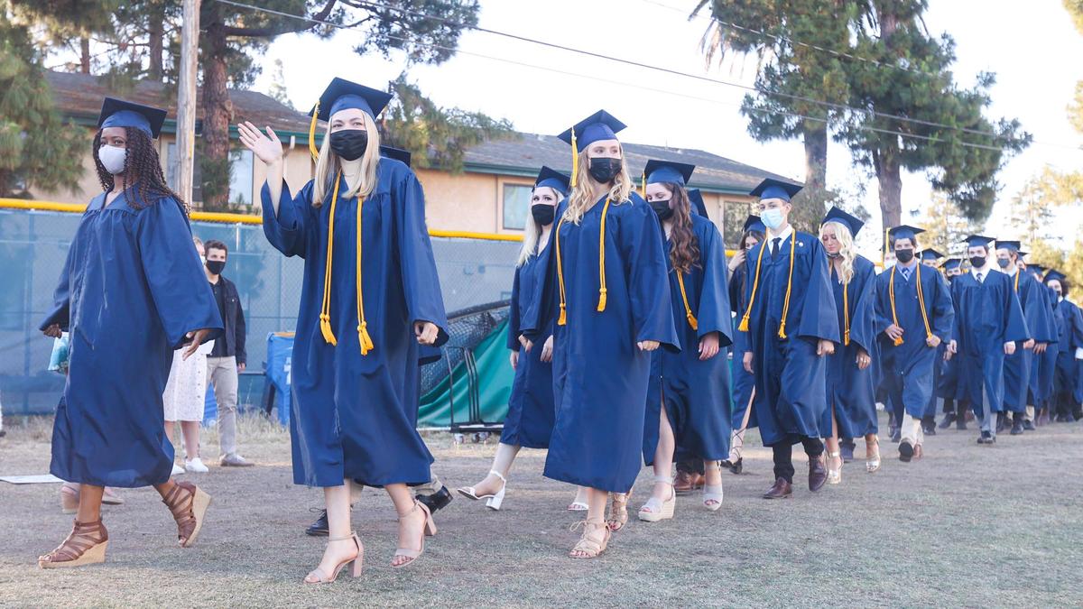 Members of Mission Prep’s Class of 2021 walk onto the field for their graduation ceremony on Friday.