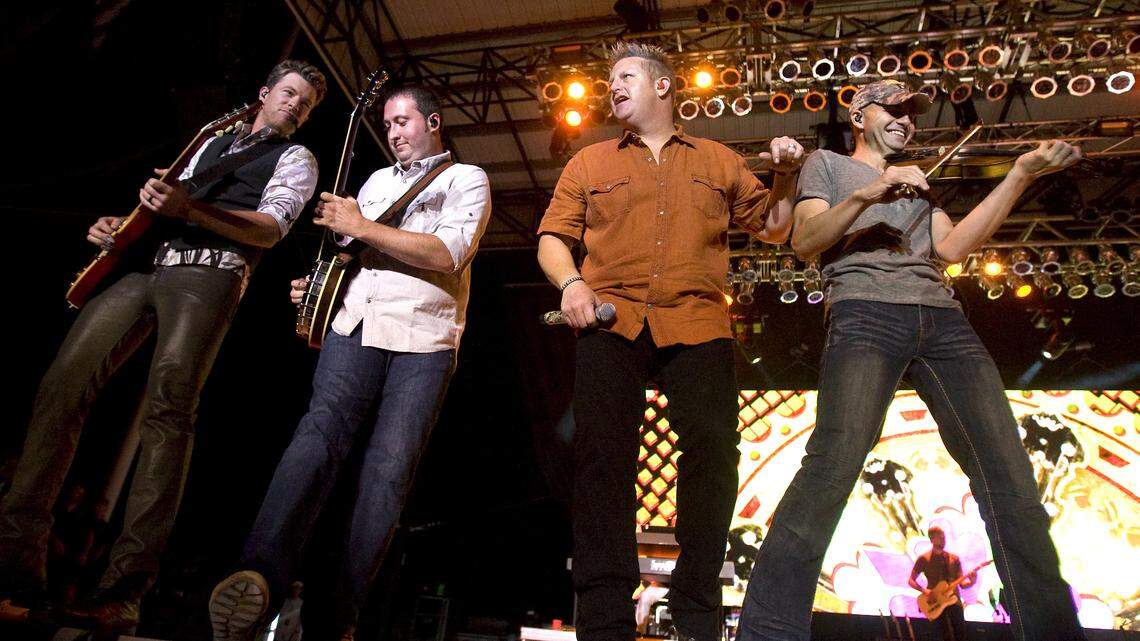 Rascal Flatts — Joe Don Rooney, guitar; Travis Toy, banjo; Gary LeVox, vocals; and John Jeansonne, fiddle — perform at the California Mid-State Fair in Paso Robles on Tuesday, July 23, 2013.