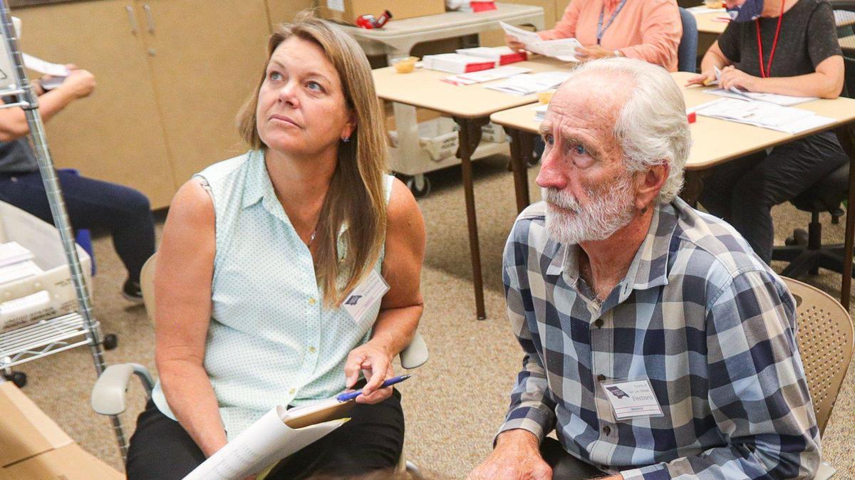 Observers Darcia Stebbens, to left, Richard Patten and Sherry Martinez watch ballots being counted at the San Luis Obispo County Clerk-Recorder’s office on Tuesday, June 14, 2022. Stebbens requested a recount for the District 4 Board of Supervisors race.