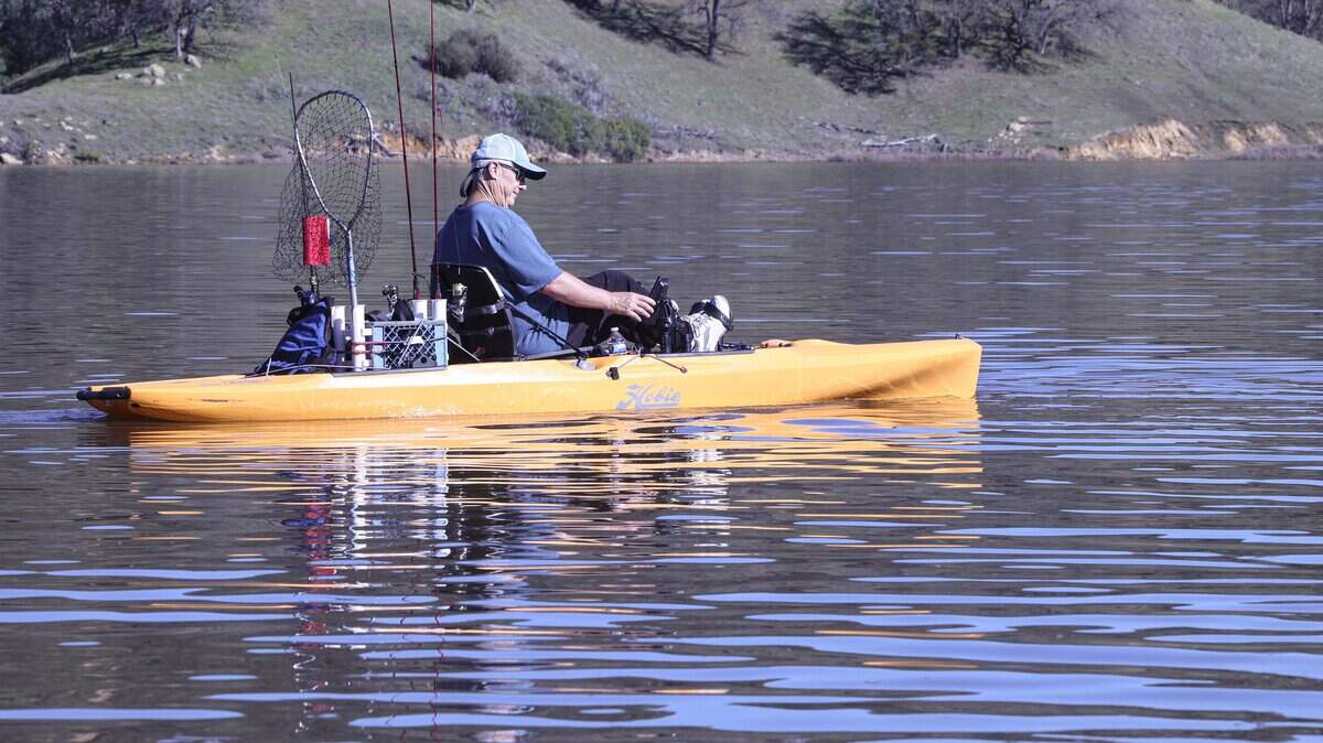 Paul Talcott paddles his kayak out to go bass fishing. The Salinas Dam on Santa Margarita Lake was at almost 102% capacity on Jan. 9, 2026.