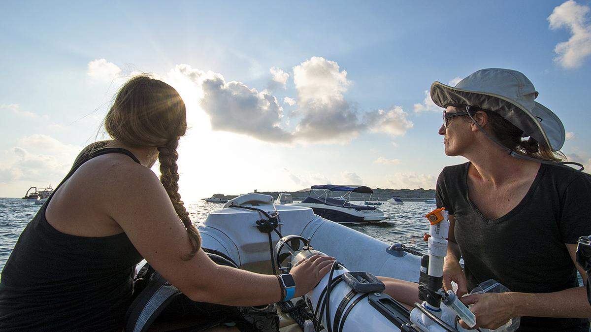 Cal Poly computer science student Katie Davis, left, and computer science professor Zoe Wood head out to deploy the autonomous underwater vehicle.