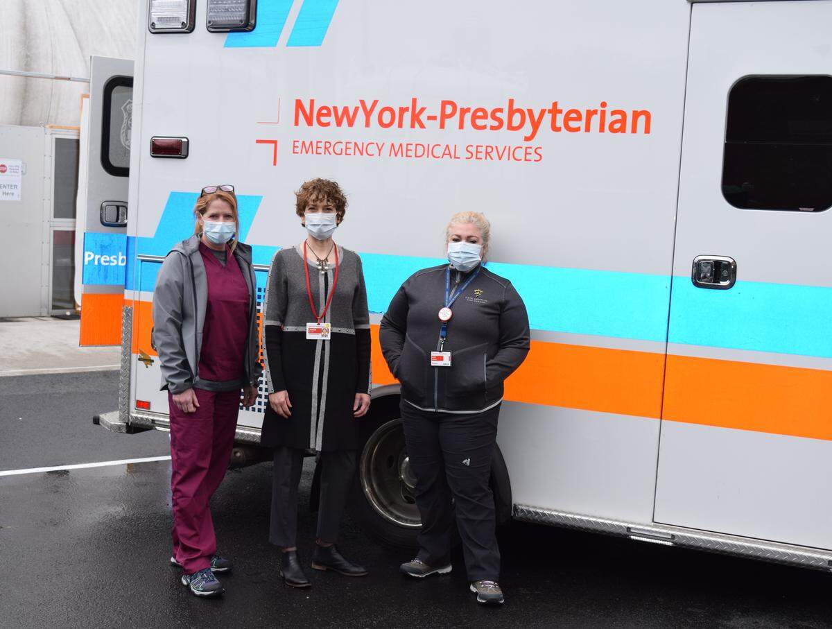 Dr. Laureen Hill, middle, with Dr. Melissa Givens, right, and chief of nursing Kate Kemplin, pose for a picture outside the New York-Presbyterian Ryan Larkin Field Hospital. Both Givens and Kemplin were military personnel brought in by Hill.