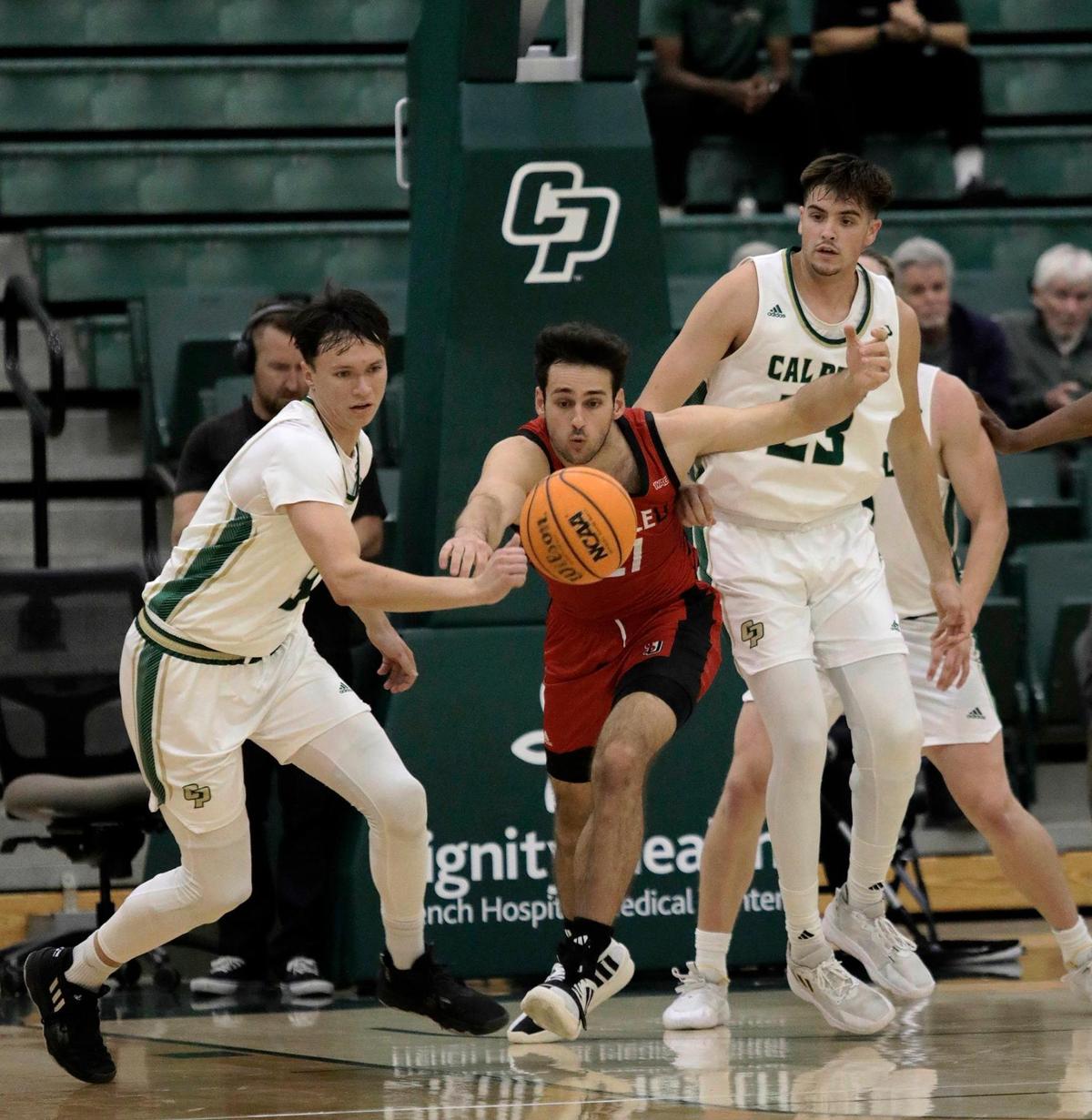 Cal Poly’s Peter Bandelj and Seattle University’s forward Viktor Rajković battle for the ball. Cal Poly beat Seattle University 75-71 in a college basketball game at Mott Athletics Center on Nov. 14, 2024.