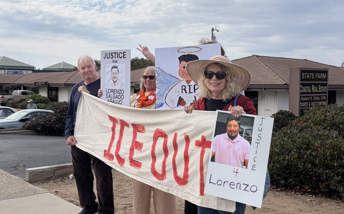 Estero Bay Indivisible organized a vigil at the corner of Los Osos Valley Road and South Bay Boulevard on July 13, 2026, to protest the killing of Lorenzo Salgado Araujo in Houston, Texas, on July 7, 2026. Los Osos residents Ted Wise (left), Holly Elkhoy and Lynn Wise joined the protest.