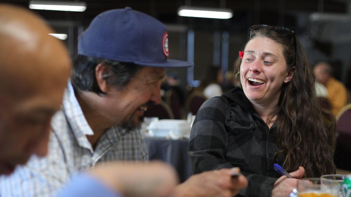 From left, Moses Flores, Johnny Isasi and Karyn Peterson laugh during the Community Thanksgiving Dinner served Wednesday, Nov. 22, 2022, at the Elks Lodge in San Luis Obispo. Over 1,500 meals were served or delivered.