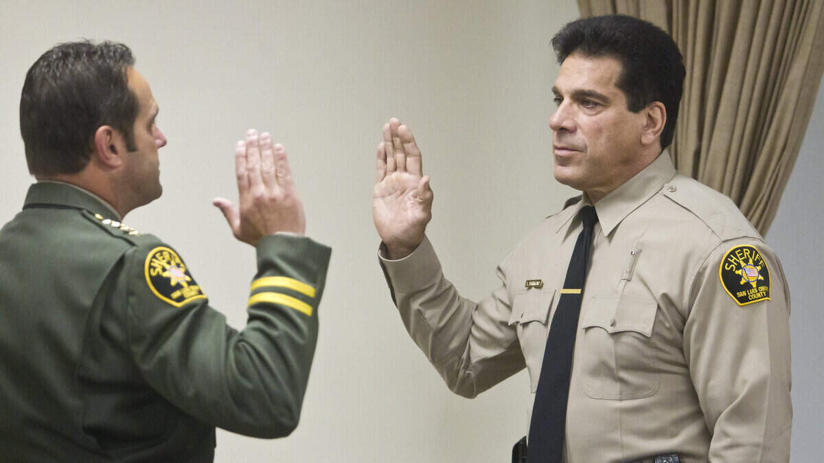 Lou Ferrigno,right, is sworn in as a reserve deputy with the San Luis Obispo's Sheriff's Department by Sheriff Ian Parkinson,left, in San Luis Obispo, Ca., on Friday, June 15, 2012. (AP Photo/The Tribune, Jayson Mellom)