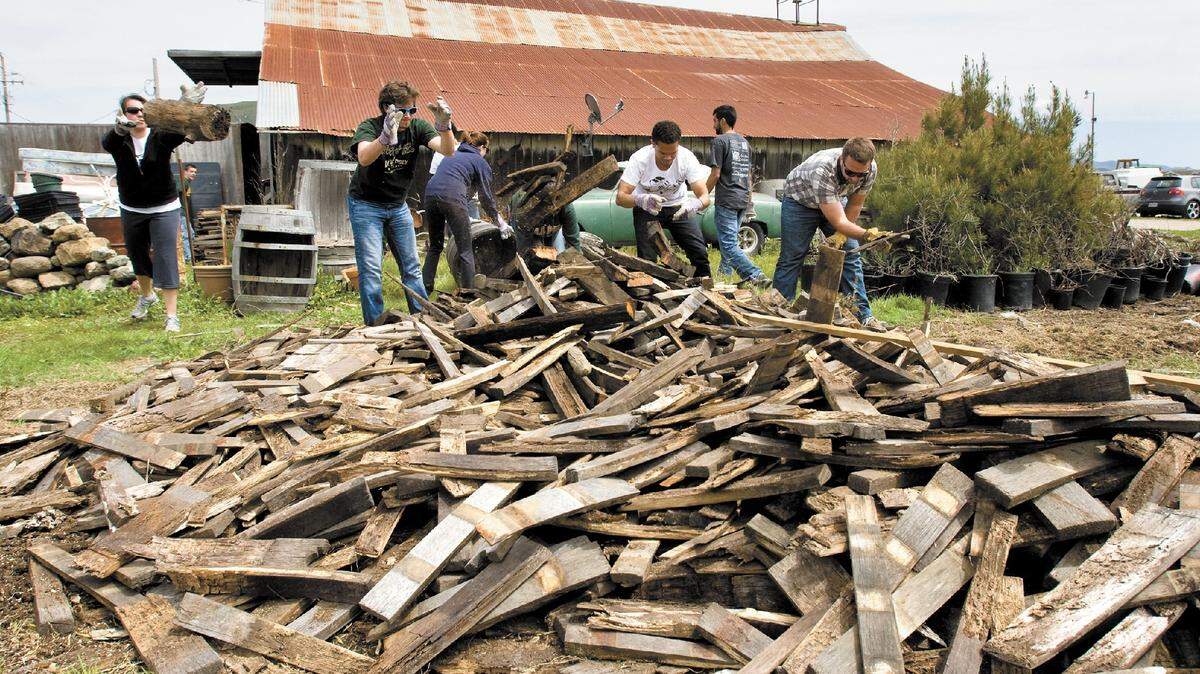 Cal Poly students begin the cleanup process at Dan DeVaul’s Sunny Acres in April 2012.