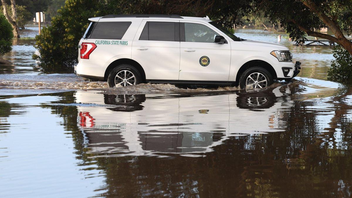 A California State Parks vehicle drives through the North Beach campground near Highway 1 in Pismo Beach on Tuesday, Jan. 10, 2023. The campground is flooded and closed.