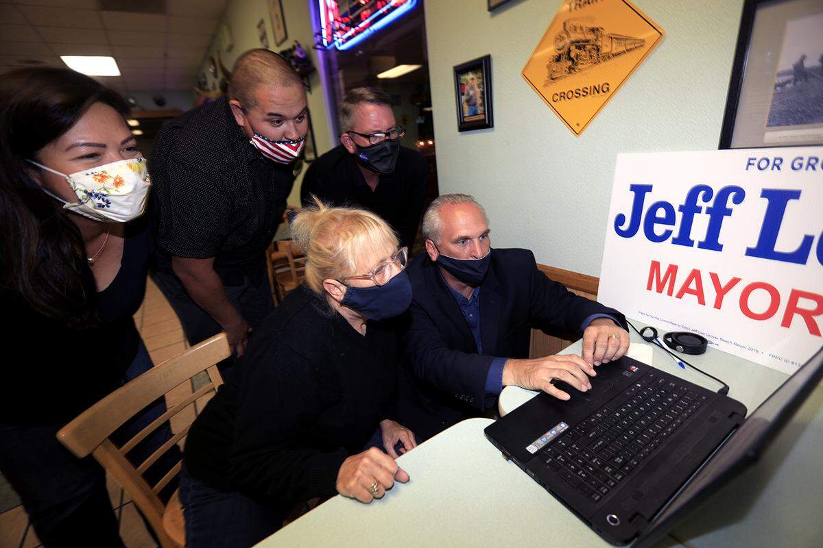 Grover Beach Mayor Jeff Lee hosted a election night party at Station Grill in Grover Beach. Lee checks first results with his wife Mary Moyer-Lee, center, Anna Miller, left, Dan Rushing and Joseph Holmes.