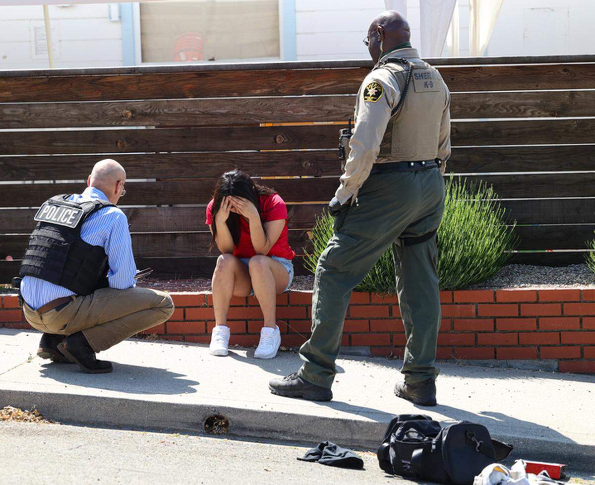Law enforcement officers talk to a person on Sydney Street in San Luis Obispo on May 18, 2023, after a police pursuit that started in Atascadero related to a previous robbery call ended with at least one arrest and others being questioned.
