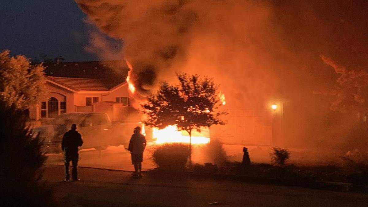 A fire burns in the garage of a home in the 2000 block of Sand Harbor Court in Heritage Ranch on Nov. 21, 2022.