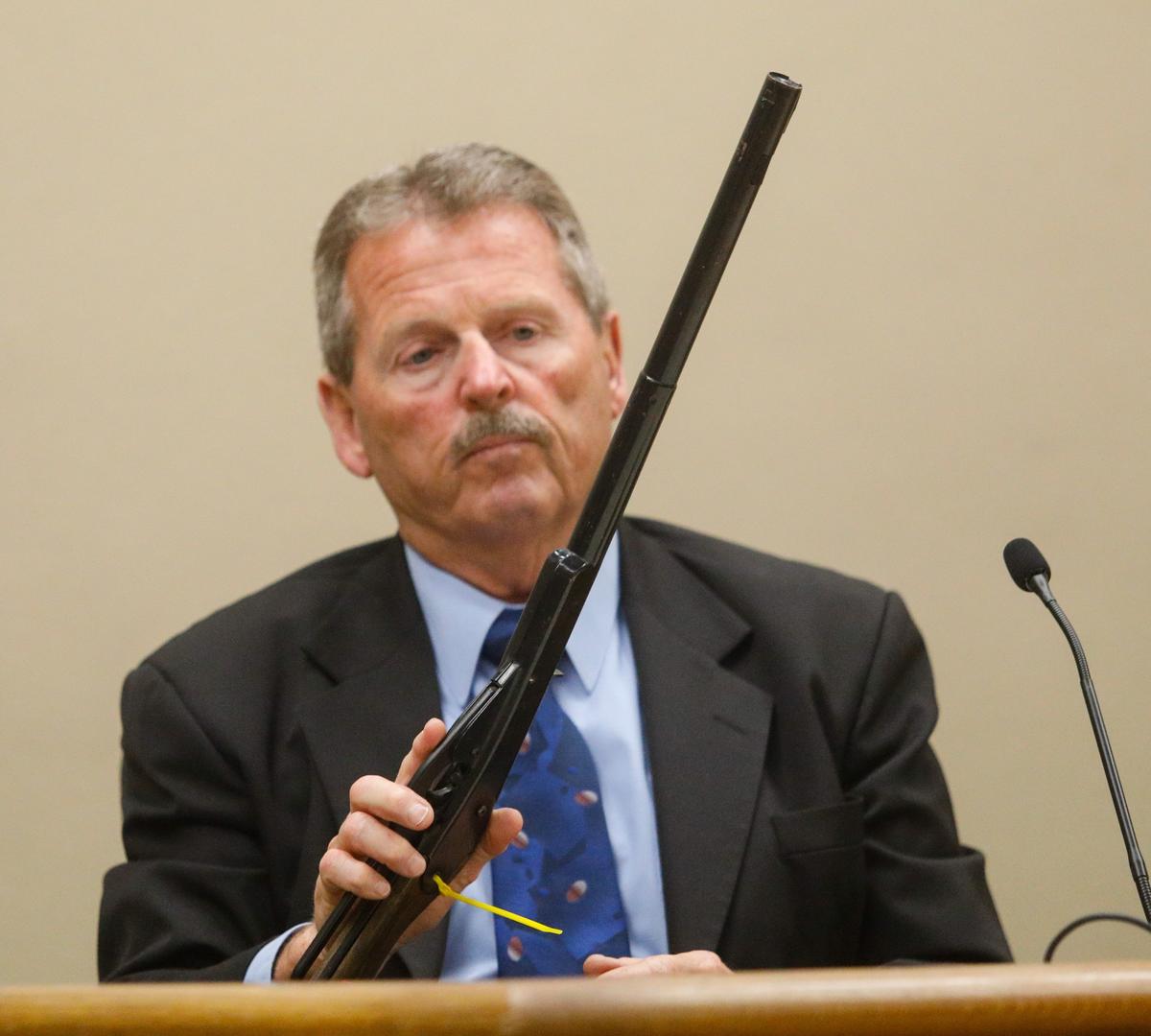 Ron Cloward, a retired lieutenant with the Modesto Police Department, currently serves as board member for the nonprofit Western States Police Canine Association. He was a witness for the defense and looks at a BB gun found at the scene of the dog attack. David Middlecamp 4-8-2019