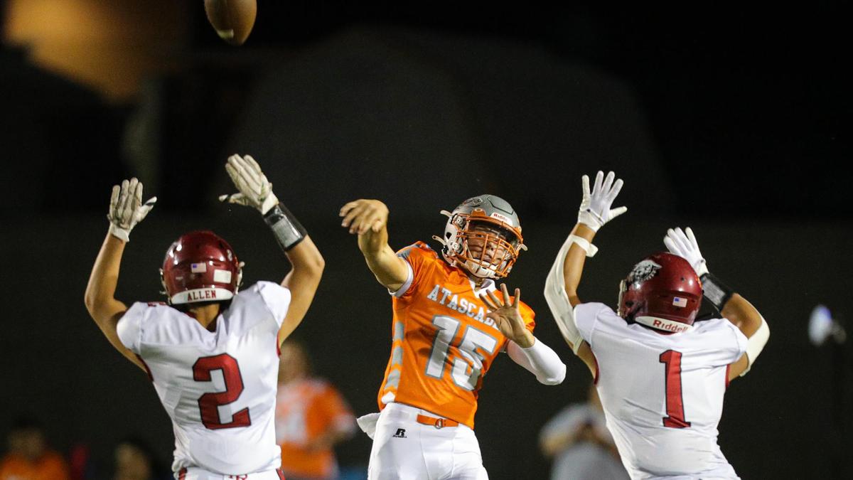 Heavy pressure by Ben Limpin (1) and Andrew Allen (2) contributed to an interception thrown by Kane Cooks on the first play of the game after kickoff. In the annual rivalry game, Paso Robles beat Atascadero 35-21 on Sept. 2, 2022.
