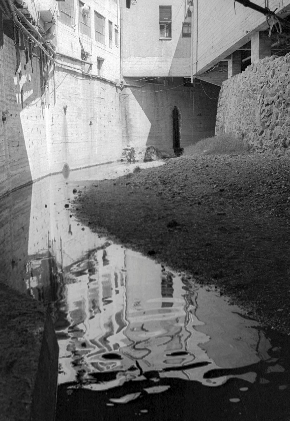 San Luis Creek flows under the city for a little over two blocks below and adjacent to Higuera Street. There are at least two air shafts but most of the path is unlit darkness. This view is from Sept. 5, 1975.