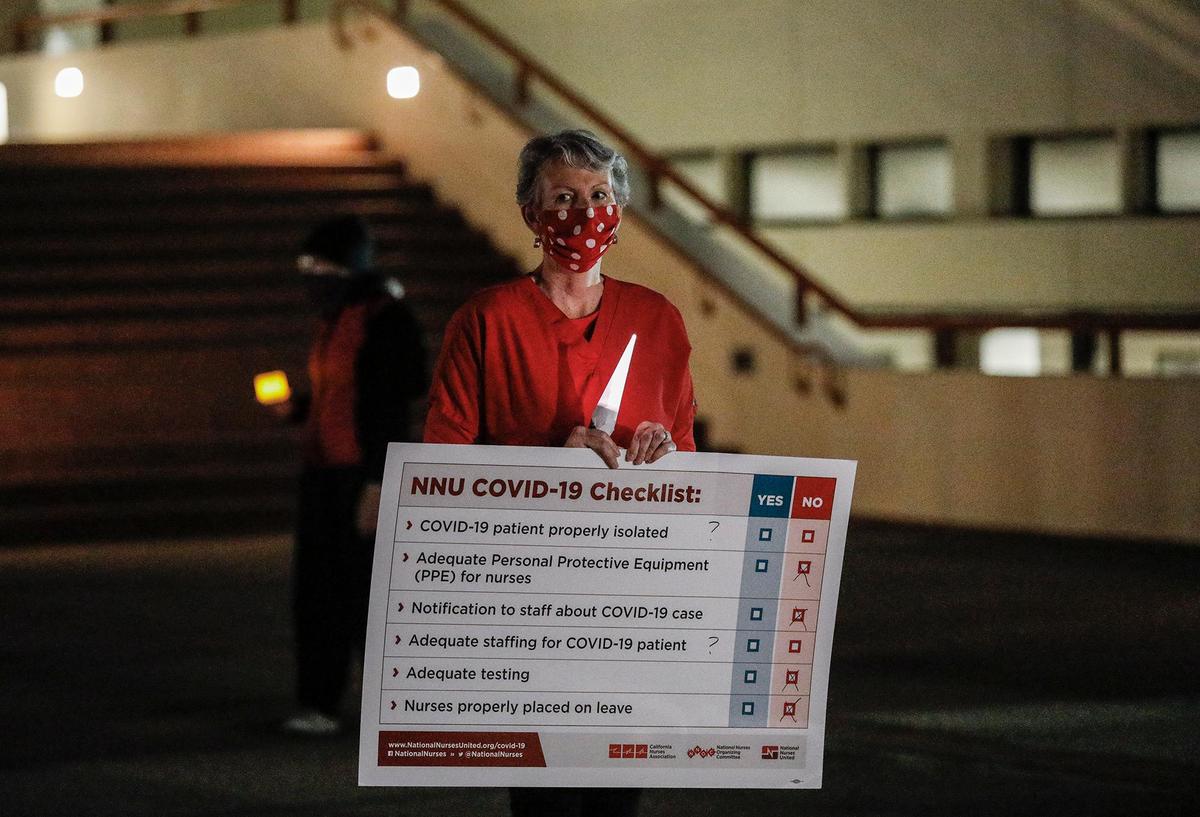 Tammy, a San Luis Obispo registered nurse, holds a sign during the vigil.