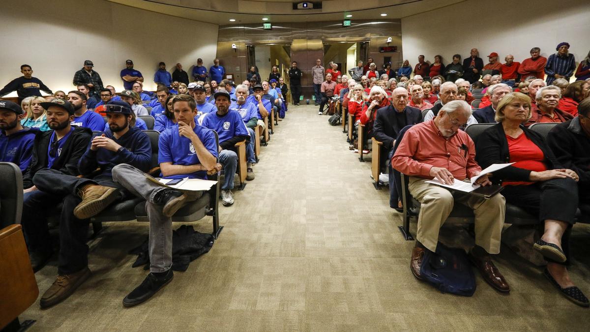 Oceano Dunes stakeholders fill the San Luis Obispo County Board of Supervisors chambers for Monday’s meeting of the Air Pollution Control District Hearing Board. People wearing red shirts are in support of more restrictions on riding to improve air quality. People in blue shirts are in support of off-road recreation at the Dunes.