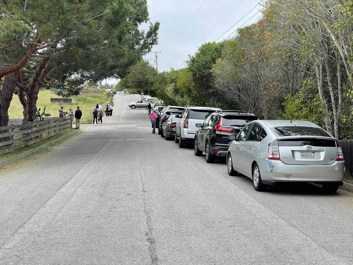 Cars line up near the Arroyo Grande home of Ruben Flores, who along with his son Paul Flores, was arrested in connection with the 1996 disappearance of Cal Poly student Kristin Smart. People from around the area flocked to the home on Tuesday, April 13, 2021, to watch officials search the house.