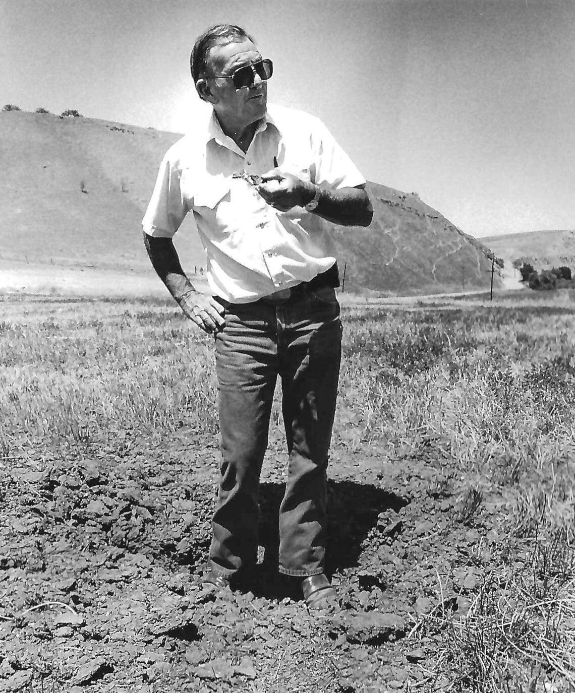 Ranch owner Stuart Bartleson examines hole gouged by shell from Camp Roberts that impacted his ranch near the San Antonio River. Story published June 28, 1989.