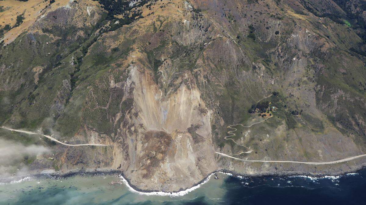 This May 22, 2017 aerial file photo shows the massive landslide along California’s coastal Highway 1 that has buried the road under a 40-foot layer of rock and dirt near Big Sur, California.