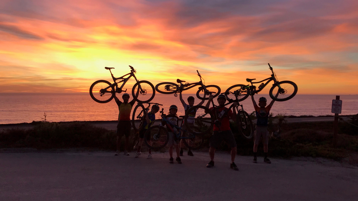 Cambria Bike Kids riders and mentors celebrate a vivid sunset on Exotic Gardens Drive on Nov. 1. From left, ride participants that day were: Jeremy Alvarez, coach Daniel Stoothof, Koa Crampton, Alexander Burton-Linn, parent Brad Crampton and John Mettier.
