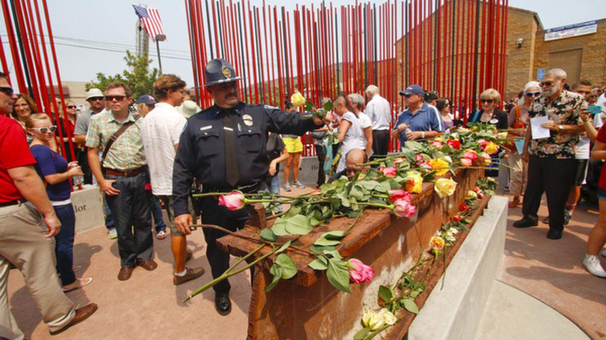Pismo Beach police Cmdr. Shawn Singleton was one of dozens of people placing roses on an I-beam from the World Trade Center on Friday, Sept. 11, 2015, during a dedication of San Luis Obispo's new WTC memorial.