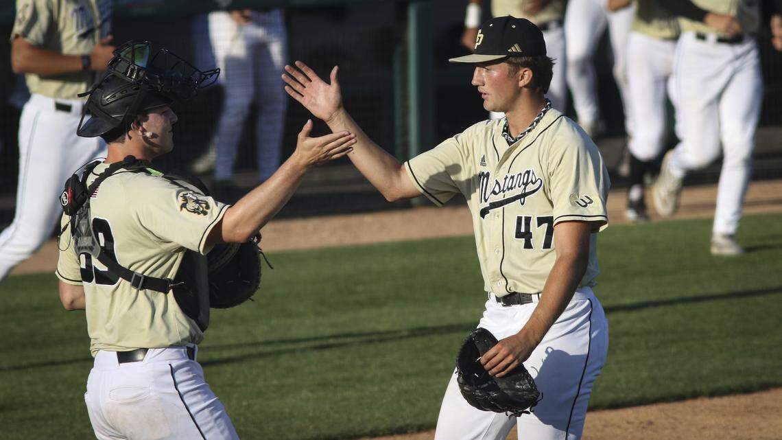 Vinnie Vanderwel, left, congratulates pitcher Luke Kalfsbeek after the win. Both players entered in the 9th inning. Cal Poly shut out Santa Clara 7-0 in a baseball game on April 28, 2026.