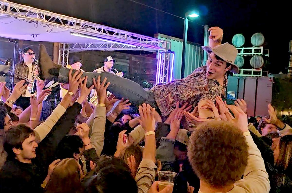 A man is crowd surfed at the Brass Mash concert at Liquid Gravity Feb. 7, 2025. Brass Mash plays the first Friday of every month at Liquid Gravity brewery in San Luis Obispo.