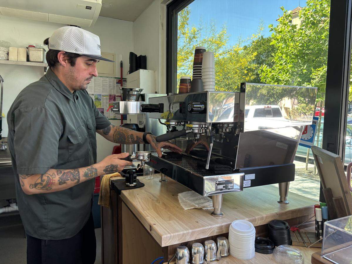 Tyler Lara makes a signature latte inside Binx Coffee in Atascadero.