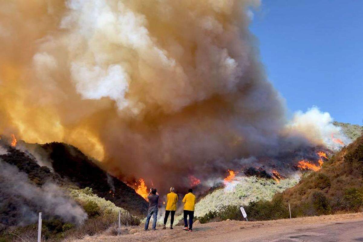 Firefighters monitor heavy flames and smoke in upper Refugio Canyon at midday Tuesday, as the Alisal Fire continued to grow.