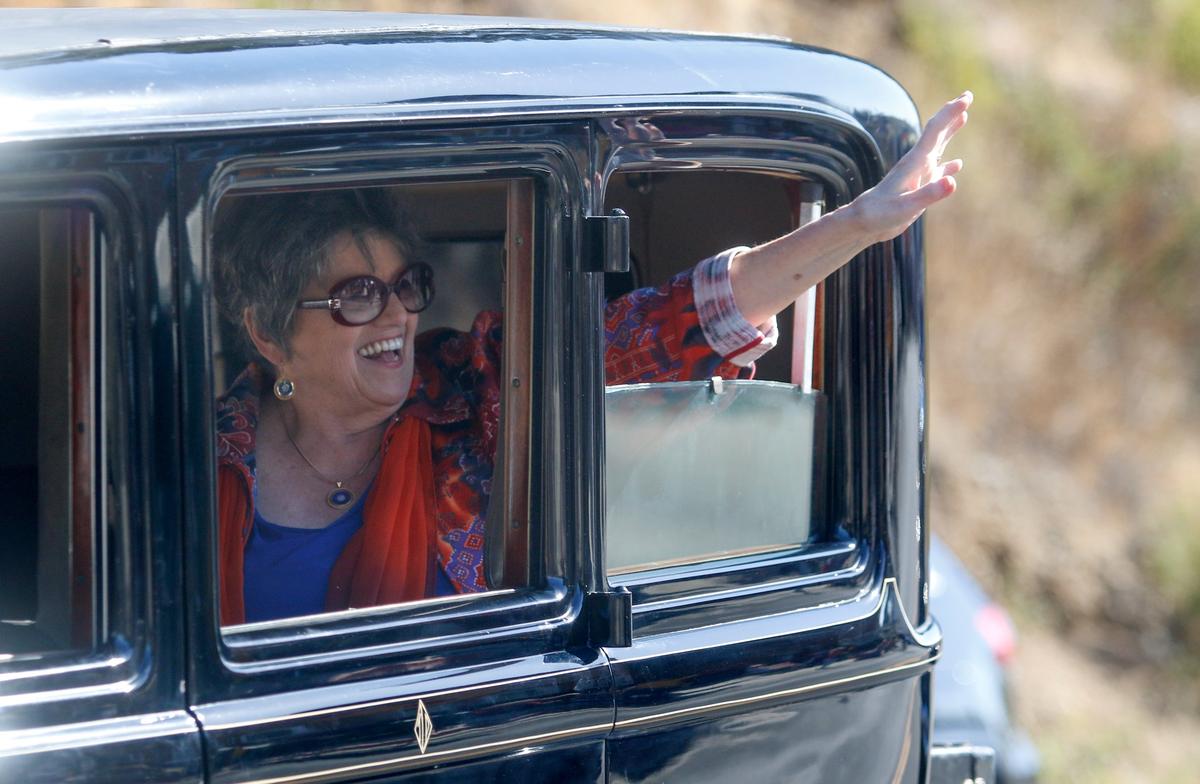Kathe Tanner, parade grand marshal and longtime Cambrian and Tribune reporter waves to the crowd during the Pinedorado Parade in 2018.