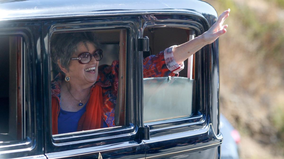 Kathe Tanner, parade grand marshal and longtime Cambrian and Tribune reporter waves to the crowd during the Pinedorado Parade in 2018.