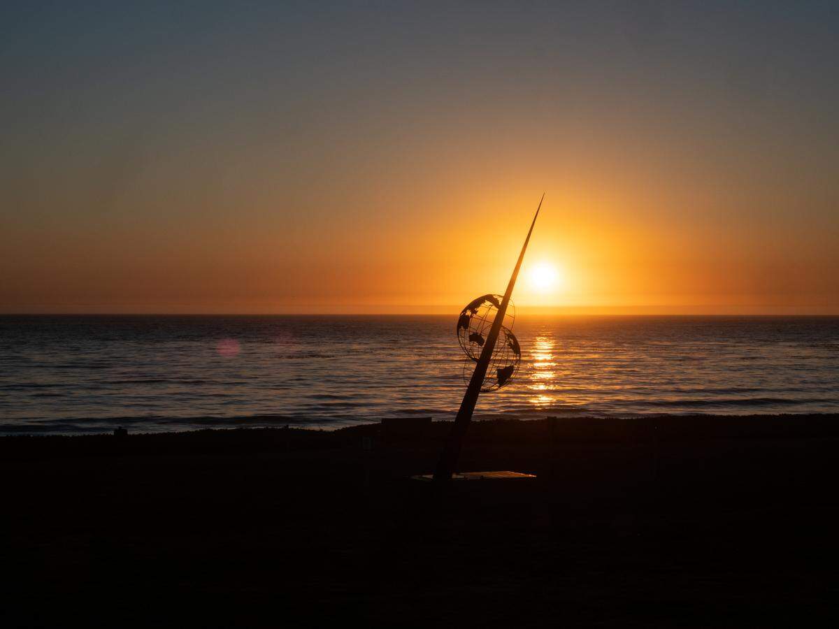 As the sun sets on Oct. 1, 2021, at a San Simeon shoreline, it highlights “Shift,” a soaring, 1,200-pound monument installed by a team of designers and creators who want to make people think about what they can do to help bring the earth and its inhabitants back into harmony.