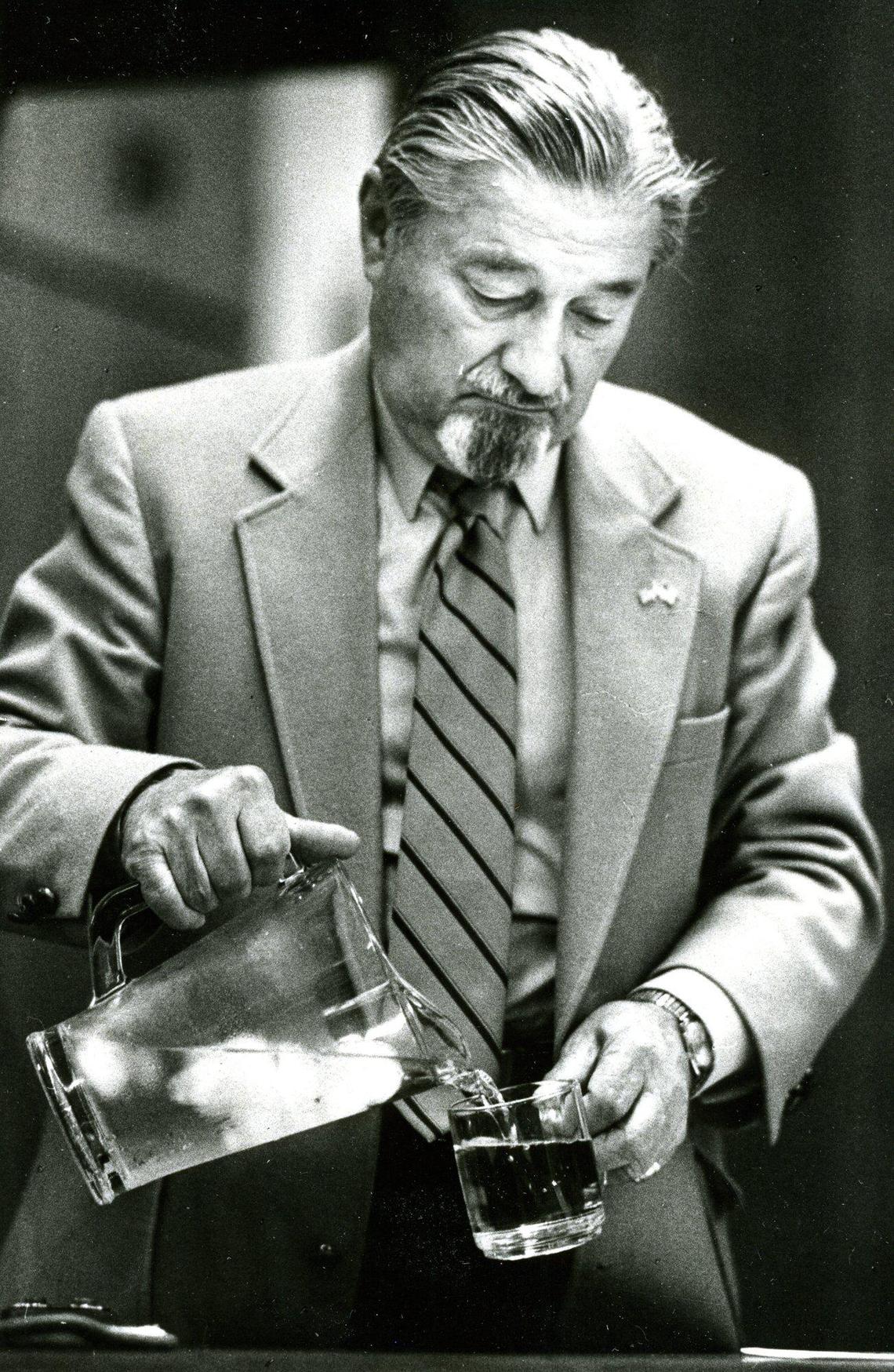 San Luis Obispo Mayor Ron Dunin pours a ration of water at a City Hall during a meeting that took the first step toward water rationing during drought March 15, 1989.