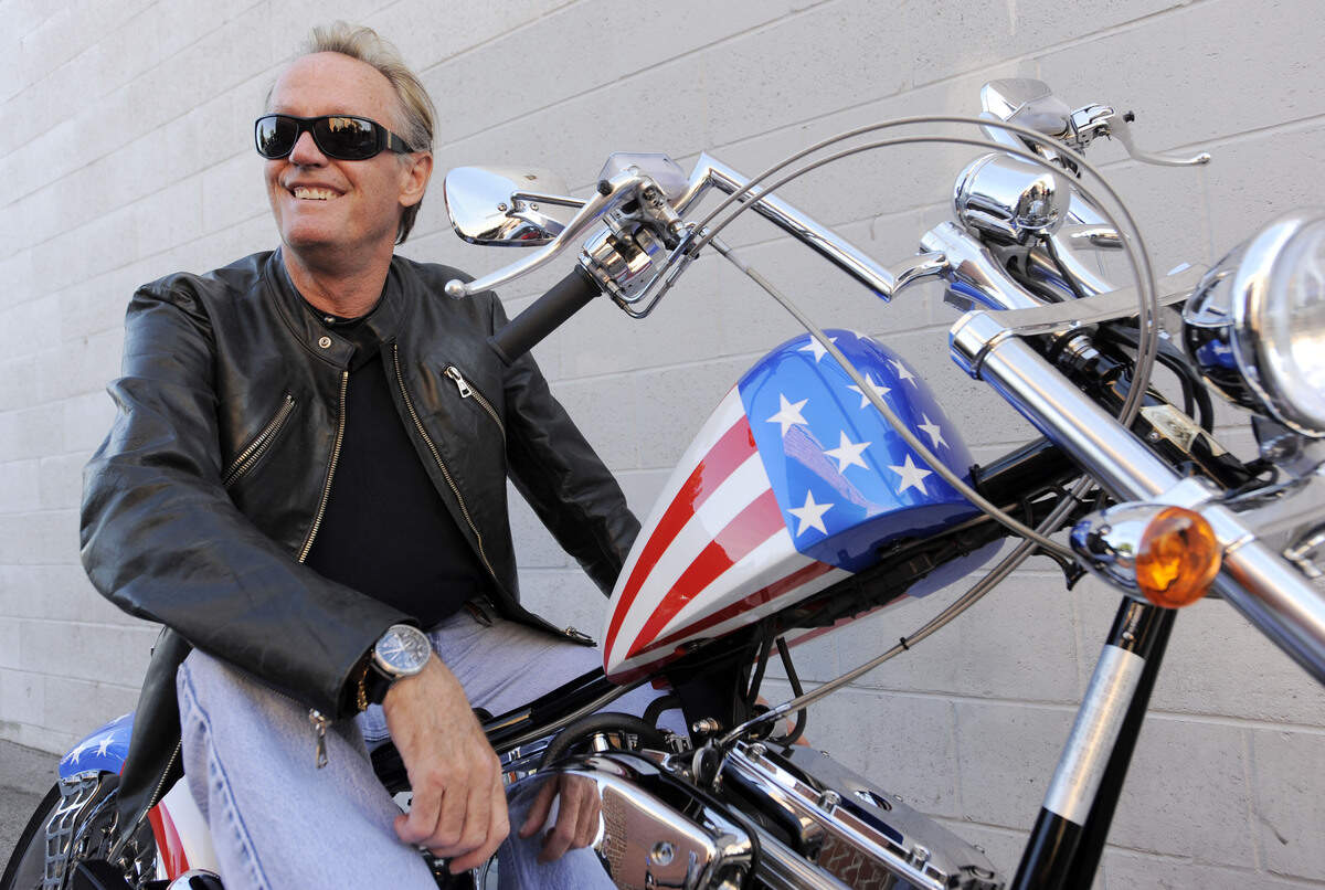 Peter Fonda, poses atop a Harley-Davidson motorcycle in Glendale, California, in 2009. Fonda, the son of a Hollywood legend who became a movie star in his own right both writing and starring in counterculture classics like “Easy Rider,” has died. His family says in a statement that Fonda died Friday, Aug. 16, 2019, at his home in Los Angeles. He was 79.