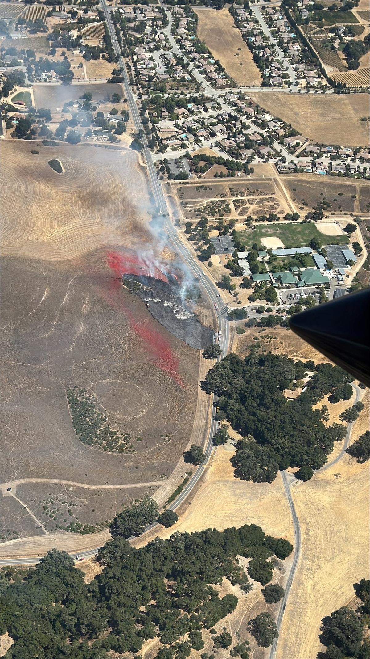 A vegetation fire burned about 2 to 3 acres of grass in a field across the street from Vineyard Elementary School in Templeton on Aug. 28, 2025.