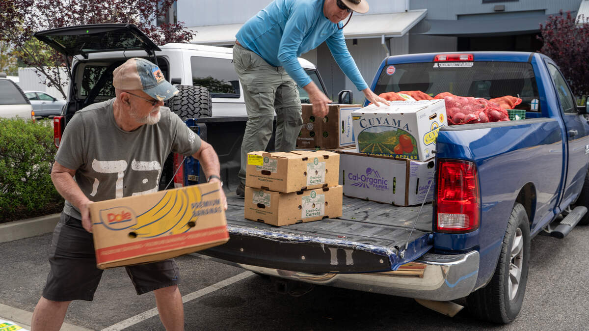 Volunteers Michael Gotschall and Byron Jones prepare to transport SLO Food Bank donations to Nipomo Community Presbyterian Church on Friday, May 1, 2026. The SLO Food Bank is one of many food insecurity organizations that are facing CalFood funding cuts in this year's state budget. Delay of the California Food Assistance Program worsens hunger. State leaders must act now to fund food benefits for immigrants and shore up the safety net.