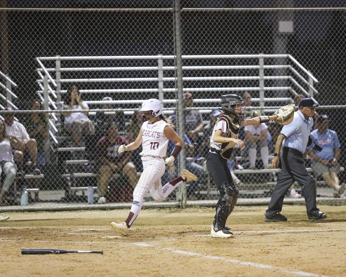 Riley Moore scores the first Bearcat run as Alie Camacho directs the throw. Nipomo beat Paso Robles 3-1 in a softball game delayed by heat on March 17, 2026.