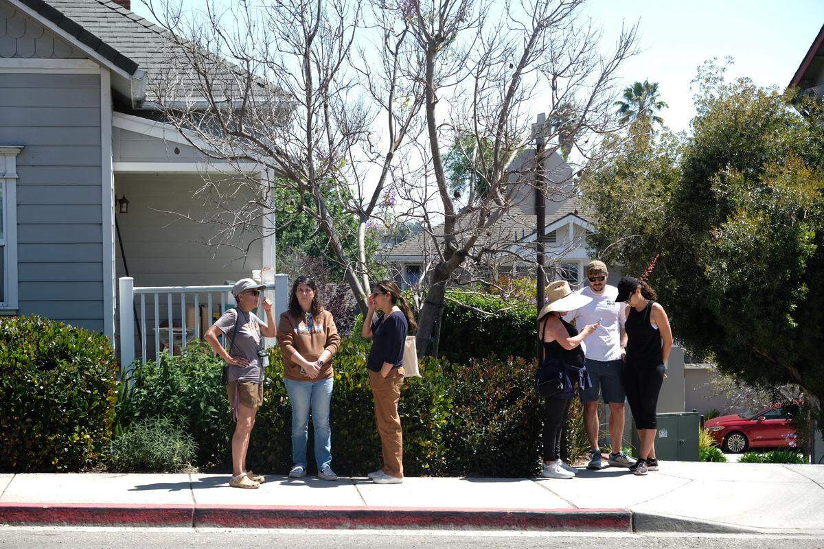 A crowd of roughly 15 people gathered at the sidewalk across from the home of Susan Flores in Arroyo Grande, California, to watch the Kristin Smart investigation play out on Saturday, May 9, 2026.